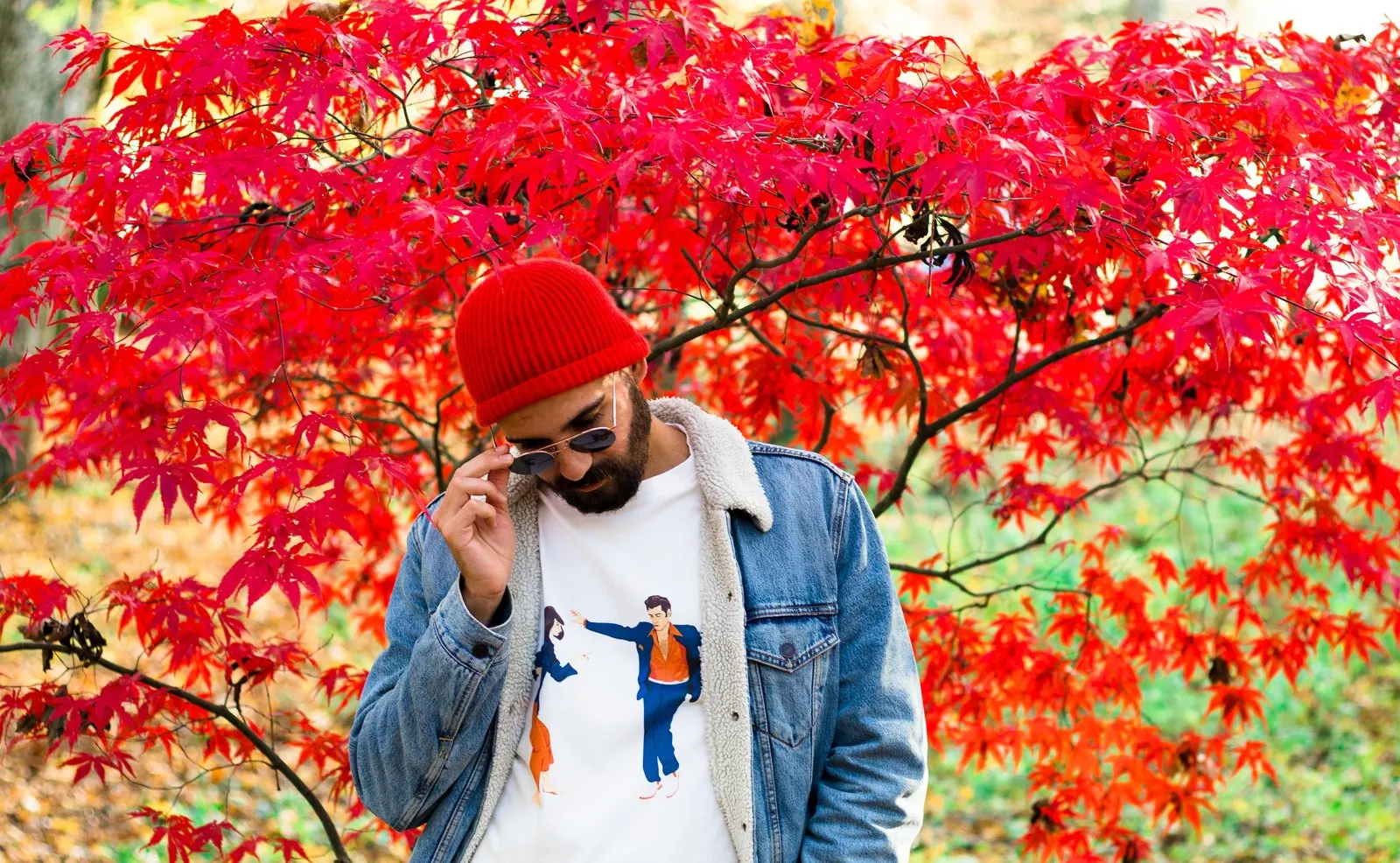 The Lovers tee under a denim jacket, red maple behind