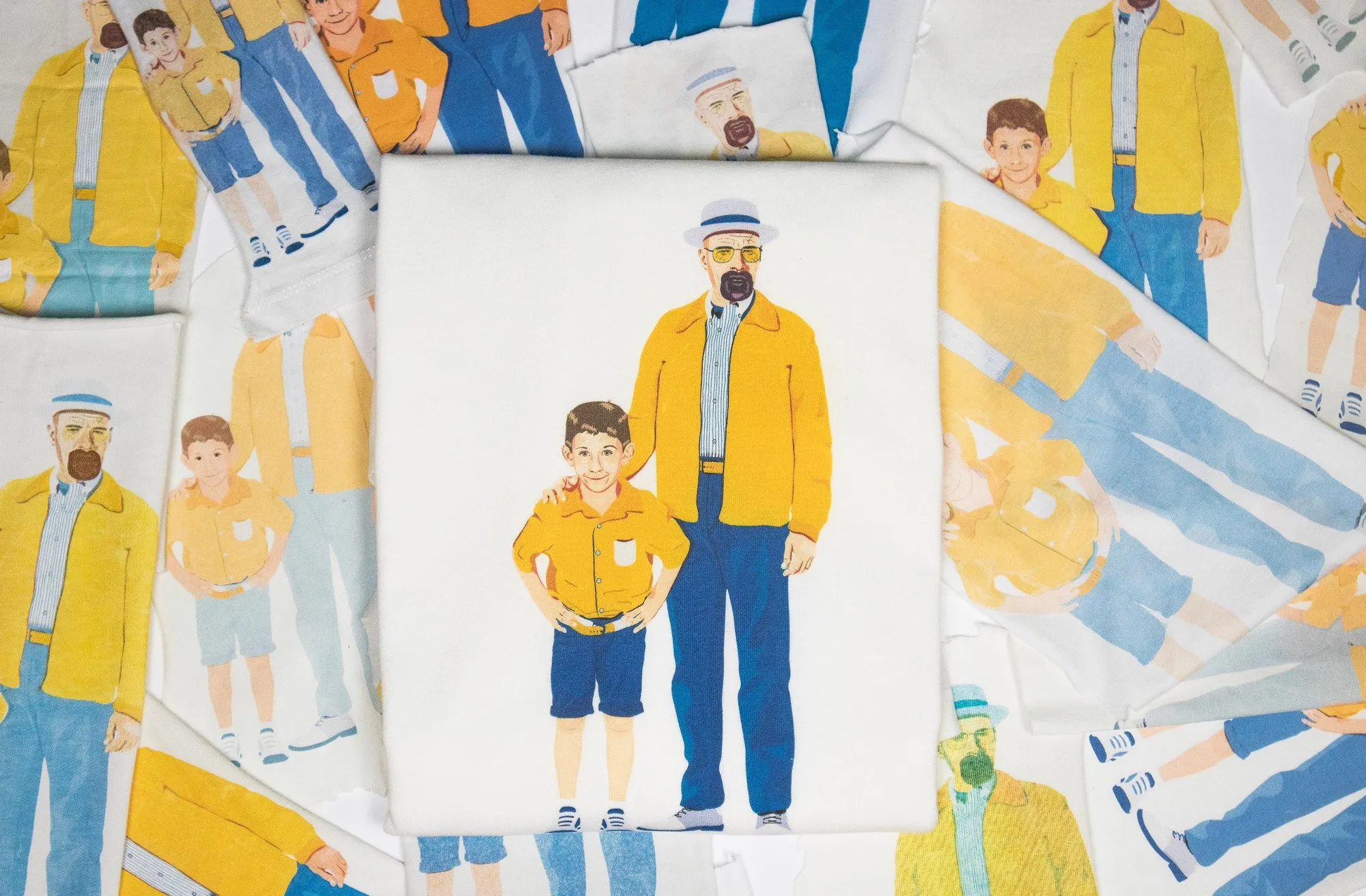 A Father & Son tee on a pile of freshly printed sheets